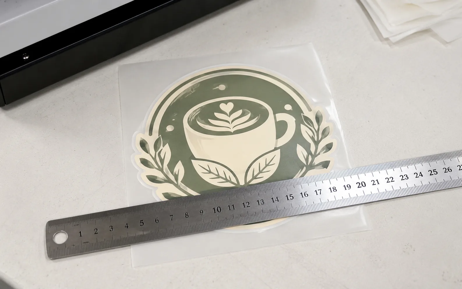 A single DTF transfer next to a ruler showing its size